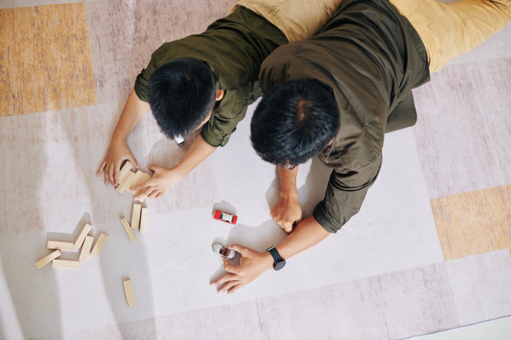 Father and son playing with toys